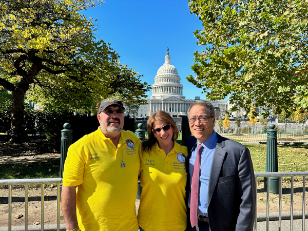 George and Angel Mueller stand in front of the Capitol with Kenny Mendez of the Asthma and Allergy Foundation of America